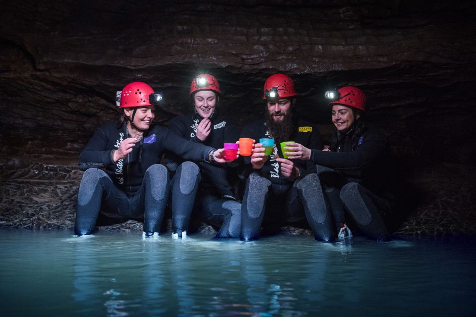 Waitomo Caves Black Abyss Ultimate Caving Experience - Tubes, wading, and water movement through the cave